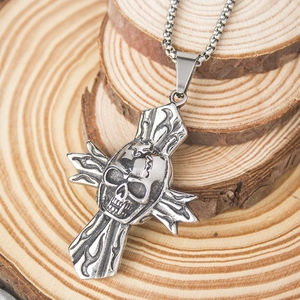 Macro shot of gothic skull cross pendant with beaded chain on rustic wooden background