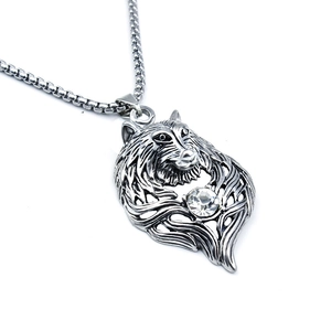 Detailed shot of a stainless steel wolf head pendant with sparkling inset crystal