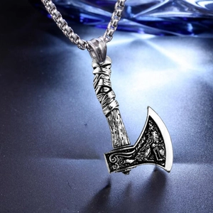 Viking battle axe necklace with intricate Nordic wolf engravings on dragon bone chain