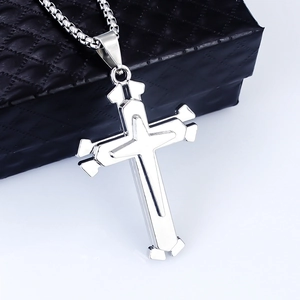 Detail of a polished stainless steel double-layered cross pendant on a square box chain
