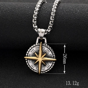 Detailed shot of compass pendant with 26mm height and 13.12g weight on black background