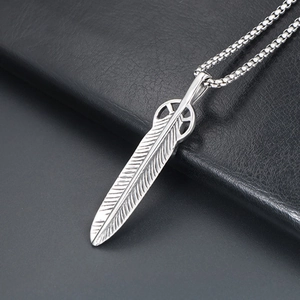 Japanese style silver feather pendant necklace with box chain on black leather background