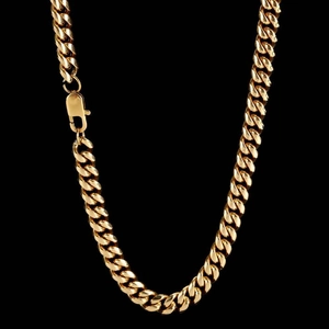 Polished gold cuban link chain detail with a durable lobster clasp on a dark background