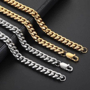 Detailed macro view of gold and silver cuban link chains with secure lobster clasps