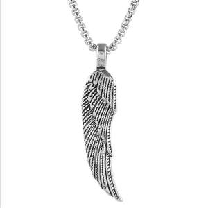 Detailed close-up of retro silver angel wing pendant with intricate feather texture