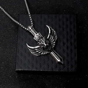 Vintage stainless steel lion pendant necklace with sword and wings on black jewelry box
