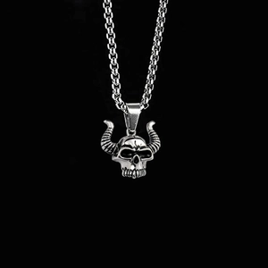 Close-up of a punk-style bull skull pendant on a box chain made of vintage titanium steel