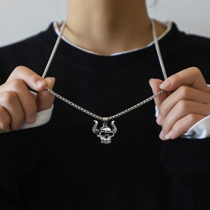 Detailed view of punk ox skull pendant with vintage texture on a stainless steel chain
