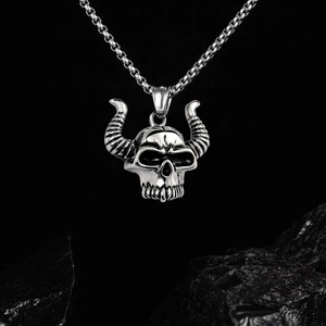 Macro shot of gothic steer skull pendant with spiral horns and black box chain details