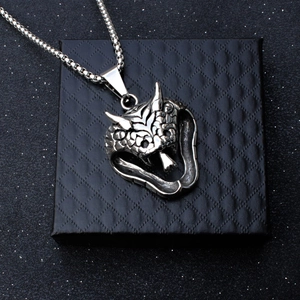 Retro stainless steel cobra pendant with round ball chain on a black jewelry box