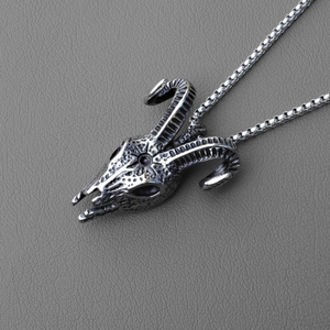 Macro shot of retro ram skull pendant with antique silver finish and steel box chain