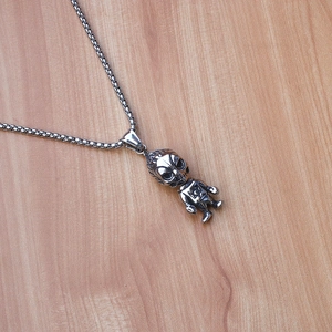 Detail of vintage silver devil skull pendant with hexagram on square pearl chain