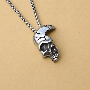 Vintage half-face skull pendant in cracked stainless steel on a silver box chain