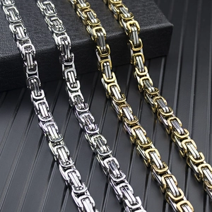 Close-up of Byzantine chain necklaces in silver and two-tone gold on a dark background