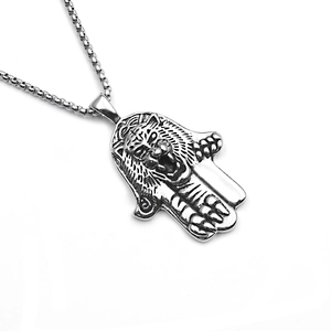 Close-up of vintage Hamsa hand pendant featuring a detailed tiger head relief in silver steel