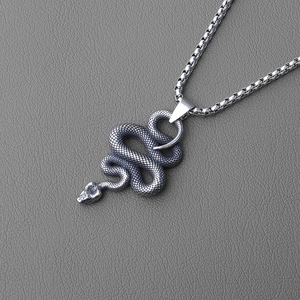 Detailed view of cobra pendant with intricate scales and gothic style on leather background