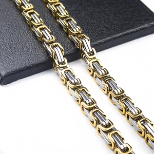 Detailed macro view of the two-tone Byzantine stainless steel chain with gold and silver links