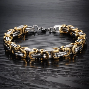 Detail of two-tone gold and silver Byzantine chain bracelet for men in titanium steel