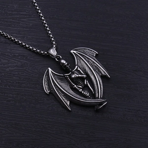 Close-up of gothic stainless steel angel skull pendant with detailed wings on a chain