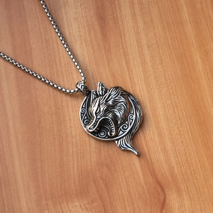 Detailed close-up of a vintage Viking wolf head pendant on a square pearl steel chain