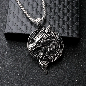 Macro shot of Viking wolf head pendant with vintage texture on a black jewelry box