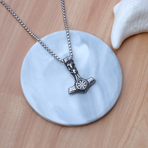 Nordic Viking Mjolnir pendant necklace in vintage silver steel on marble plate