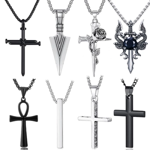 Set of eight assorted stainless steel pendants including crosses and ankh on white background