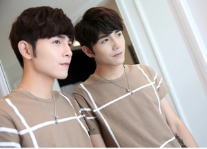 Detail of khaki men's t-shirt with geometric white grid pattern and round neckline