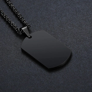 Close-up of matte black stainless steel dog tag necklace with matching beaded chain