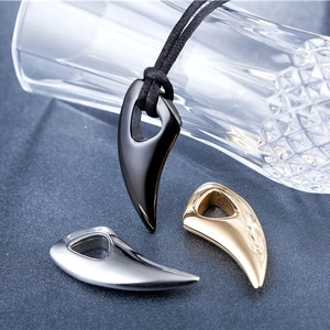 Polished wolf tooth pendants in black, silver and gold with a black woven cord