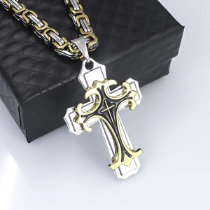 Macro detail of gothic triple-layer cross pendant with gold ornate floral overlay patterns