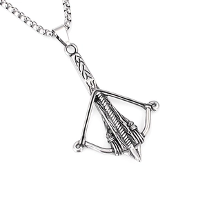 Macro shot of retro stainless steel crossbow pendant showing vintage metallic textures