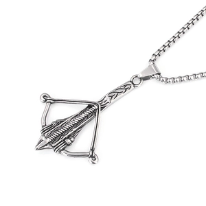 Detail of vintage silver crossbow pendant showing intricate mechanical textures and box chain