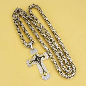 Vintage gold and silver layered cross pendant on a bicolor Byzantine chain necklace