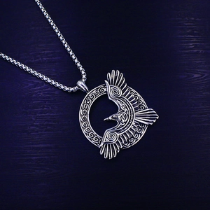 Macro shot of Viking raven pendant with Celtic knot patterns and steel chain links
