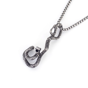 Close-up of gothic vintage snake pendant with detailed scales on a pearl box chain