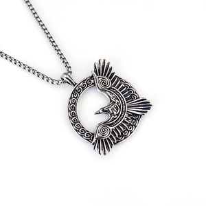 Detailed macro view of a Viking raven pendant with Celtic knots in vintage stainless steel