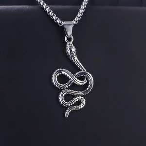 Detailed close-up of a coiled snake pendant with textured scales and silver finish