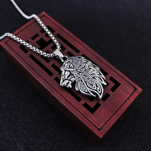 Vintage stainless steel lion head pendant with Celtic knot patterns on a box chain necklace