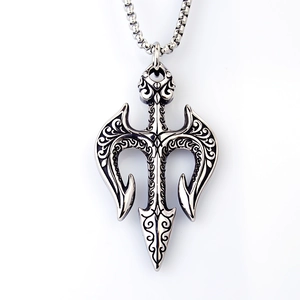 Detailed shot of retro stainless steel Poseidon trident pendant with black scroll motifs