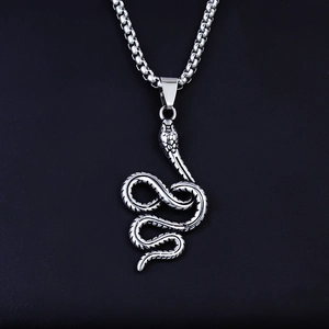 Macro shot of silver stainless steel coiled snake pendant with detailed scales and box chain