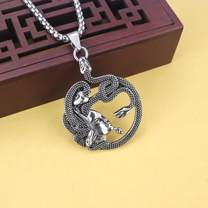 Macro shot of vintage stainless steel Medusa pendant with snakes and a box chain