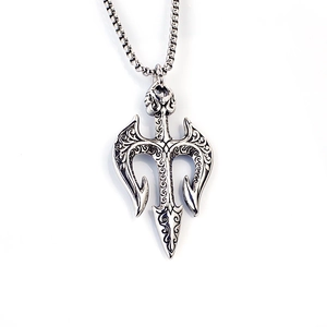 Detail of vintage silver Poseidon trident pendant with baroque engravings and bead chain