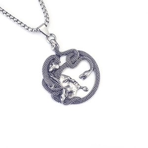 Detailed macro view of silver Medusa head pendant with intricate snake hair textures