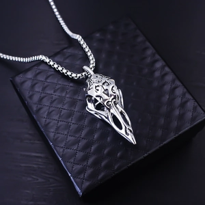 Macro shot of Viking raven skull pendant with ornate carvings on black jewelry box