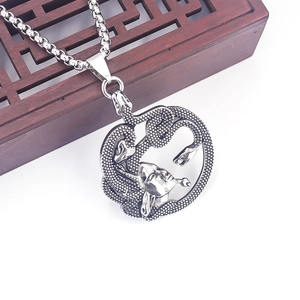 Macro shot of silver stainless steel Medusa pendant with detailed snake hair texture