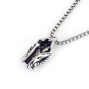Macro shot of vintage silver hood assassin pendant with engraved gothic details