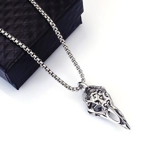 Close-up of a Nordic Viking crow skull pendant with engraved details on a black jewelry box