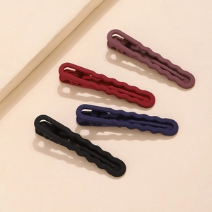 Set of four matte wavy hair clips in purple, red, navy and black for daily hairstyling