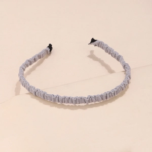 Close-up of light grey pleated fabric headband with fine accordion texture detail
